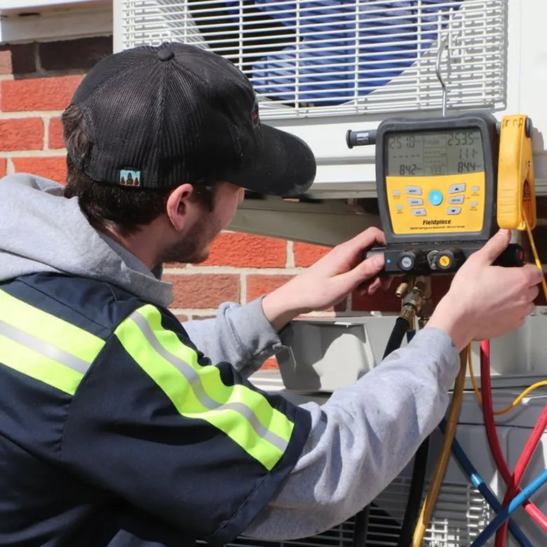J&K technician Justin checking refrigerant gauges