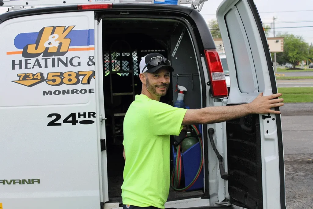 J&K Heating & Cooling technician with a customer