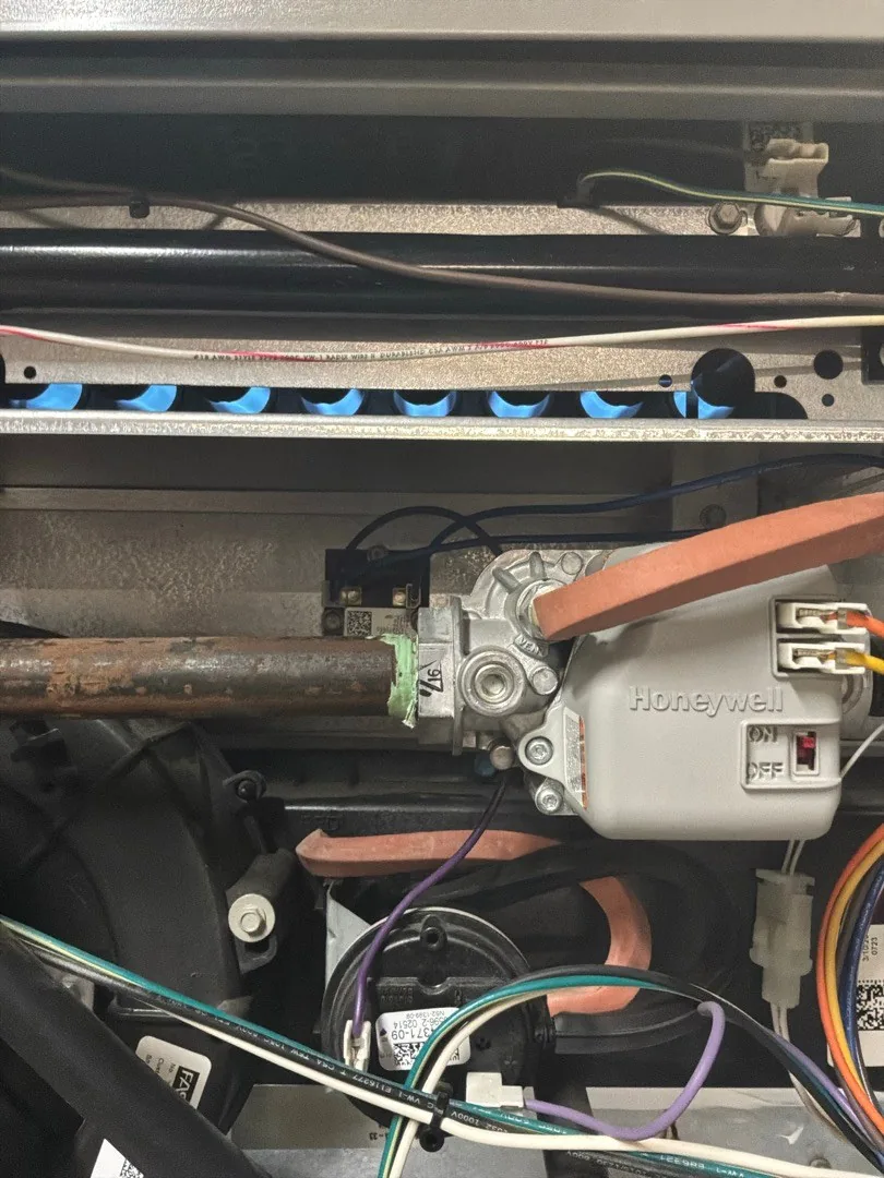 Technician checking a furnace's burners and gas valve